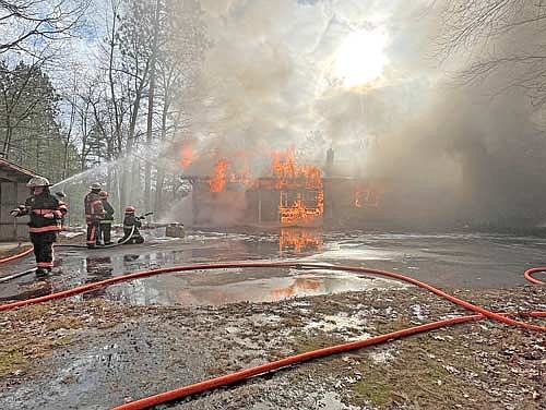 Firefighters spray water onto a Baker Lake Road building at the conclusion of a structure fire training on Saturday, Dec. 2, in Minocqua. (Photo by Trevor Greene/Lakeland Times)