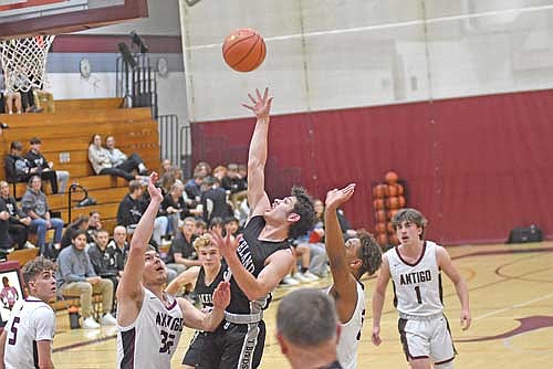 Jalend Cobb shoots a floater defended by Antigo’s Luke Bastle in the first half Friday, Dec. 8 at Sheldon Fieldhouse in Antigo. Cobb finished the game with 13 points. (Photo by Brett LaBore/Lakeland Times)