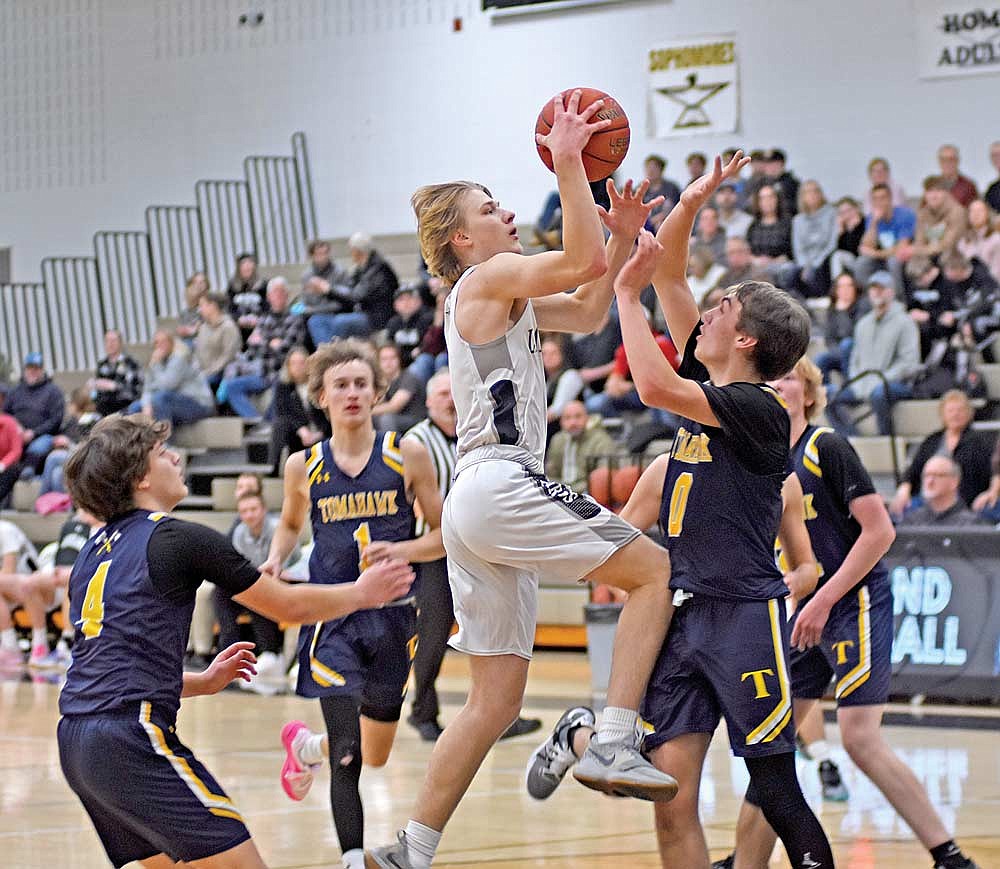 Danny Gahler gets fouled by Tomahawk’s Easton Sleaper (0) on a layup attempt in the first half of a 69-22 win Tuesday, Dec. 19 at Ted Voigt Court in Minocqua. Gahler made both of his free throws as part of his 17 points. (Photo by Brett LaBore/Lakeland Times)