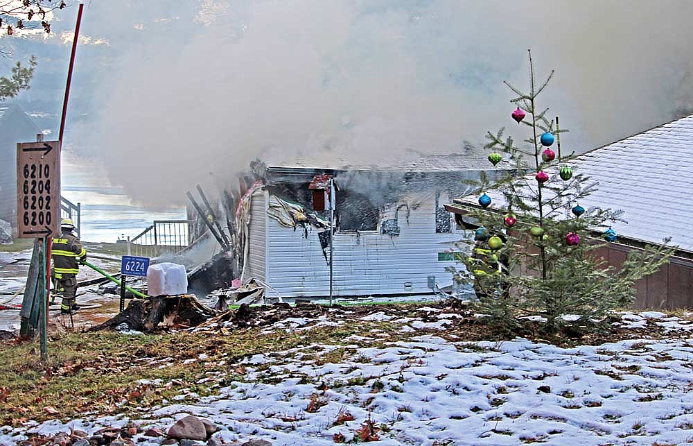 Firefighters with the towns of Newbold, Pine Lake and Lake Tomahawk work to fully extinguish a home on South Ranch Road on Thursday, Dec. 14, in Newbold. (Photo by Trevor Greene/Lakeland Times)