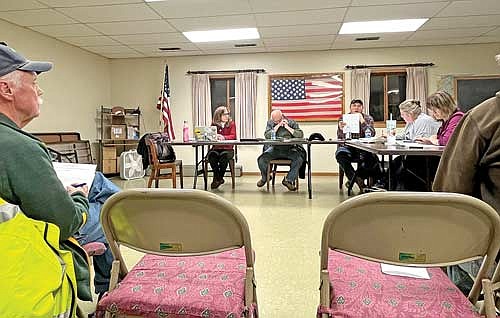 Fire chief Warren Johnson, left, town supervisor Ann Sloane and town chairman Bill Felch listen to town supervisor John Smith read residents’ concerns and suggestion regarding the Pike Lake Fire Department during a meeting Tuesday, Dec. 19, in Fifield. (Photo by Trevor Greene/Lakeland Times)