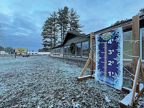 Light over-night snow shows no appreciable accumulation on the Let’s Minocqua Visitors Bureau accumulated snowfall board on Wednesday, Dec. 27, in Minocqua. (Photo by Trevor Greene/Lakeland Times)