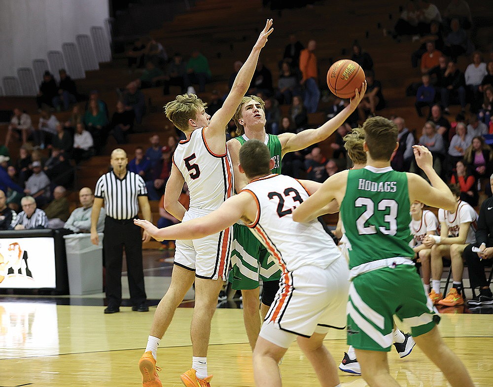 Rhinelander’s Truman Lamers puts up a shot against Marshfield’s Brooks Hinson during the first half of a non-conference boys’ basketball game in Marshfield Tuesday, Jan. 2. Lamers led the Hodags with 14 points, but Hinson had 28 for the Tigers, which won the game 70-34. (Bob Mainhardt for the River News)