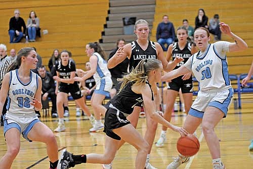 Bobbi Lee drives in the paint defended by Watertown’s Drew Hinrichs (30) during the second half Friday, Dec. 29 at Watertown High School. Lee’s free throw was the first point of the second half for the Thunderbirds. (Photo by Brett LaBore/Lakeland Times)