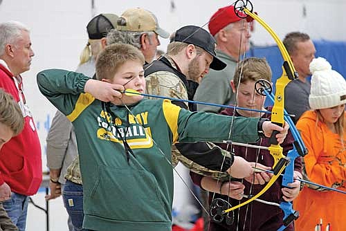 Eli Schmitz aims his arrow at the target for an archery contest during the Northwoods Youth Deer Hunt Challenge at Lakeland Union High School on Monday, Jan. 1, in Minocqua. Turn to pages 26 - 29 for more event photos. (Photo by Trevor Greene/Lakeland Times)