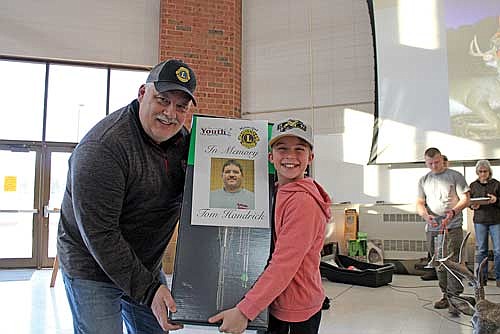 The Northwoods Youth Deer Hunt Challenge held its 20th annual awards banquet Monday, Jan. 1 at Lakeland Union High School in Minocqua. Over 400 people attended any prizes were awarded after a meal prepared by the Minocqua Lions was enjoyed. Prior to that, youth participated in different educational games. Pictured: Max Miljevich of Rhinelander wins a Centerpoint crossbow in memory of Tommy Handrick presented by Jamie Nimsgern. Handrick, a well-known local outdoorsman and wrestling coach in both Rhinelander and Minocqua, died in March 2018 when his skid steer broke through the ice on a lake near Watersmeet, Mich. (Photo by Trevor Greene/Lakeland Times)