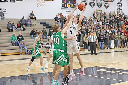 Hakken Berklund attempts a shot over Rhinelander’s Seth Nofftz in the first half Friday, Jan. 5 at Ted Voigt Court in Minocqua. (Photo by Bob Mainhardt for the River News)