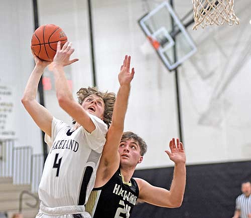 Hakken Berklund attempts a shot against the defense of Hayward’s Miles McCallum in the first half of an 80-66 win Tuesday, Jan. 9 at Ted Voigt Court in Minocqua. Berklund scored a career-high 20 points. (Photo by Brett LaBore/Lakeland Times)