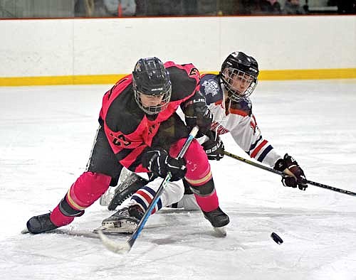 Hunter Gualdoni battles down low for the puck with Northwest’s Noah Nelson in the third period Tuesday, Jan. 9 at Lakeland Ice Arena in Minocqua. (Photo by Brett LaBore/Lakeland Times)