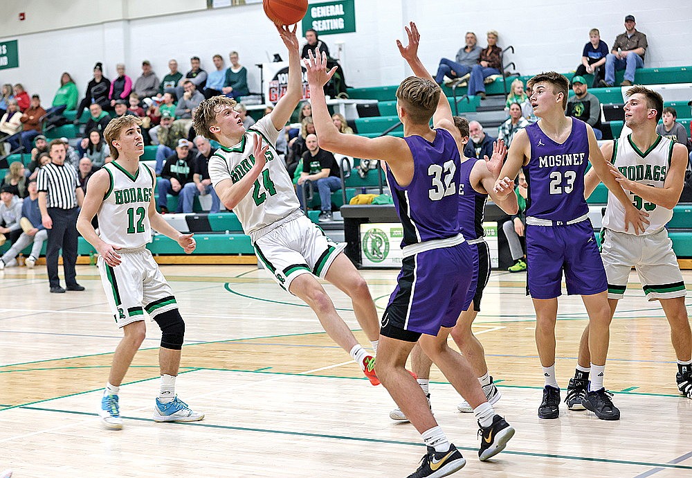 Rhinelander’s Will Gretzinger fades away from Mosinee’s Landen Thomer on a shot during the second half of a GNC boys’ basketball game at the Jim Miazga Community Gymnasium Tuesday, Jan. 9. Rhinelander fell to Mosinee 70-58 in a battle for first place in the GNC. (Bob Mainhardt for the River News)