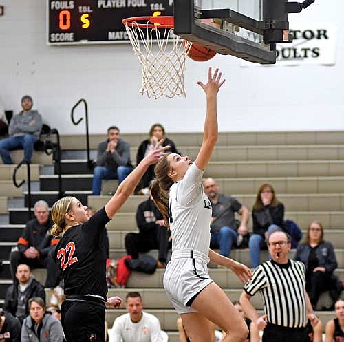 Kristina Ouimette attempts a layup followed by Marshfield’s Raella Schueller in the first half Tuesday, Jan. 16 at Ted Voigt Court in Minocqua. Ouimette scored a career-high 38 points with seven 3-pointers. (Photo by Brett LaBore/Lakeland Times)