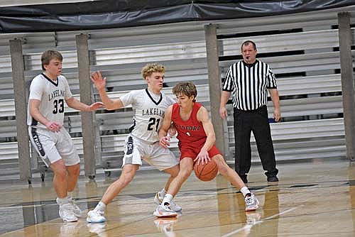 Evan Zoch guards Medford’s Tanner Hraby with Nate Ariola (33) looking on in the second half Friday, Jan. 19 at Ted Voigt Court in Minocqua. Hraby led all scorers with 26 points. (Photo by Brett LaBore/Lakeland Times)