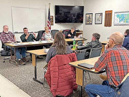 Pine Lake residents listen as town chairman Jim Flory, second from left, addresses the issue of the town’s concerns about the financial impact of the town’s participation in the Rhinelander Library District during a town board meeting on Wednesday, Jan. 17, 2024. Also pictured, from left to right, are supervisor Tim Oestreich, clerk Cindy Skinner and supervisor Ron Lueneburg. (Photo by Heather Schaefer/River News)