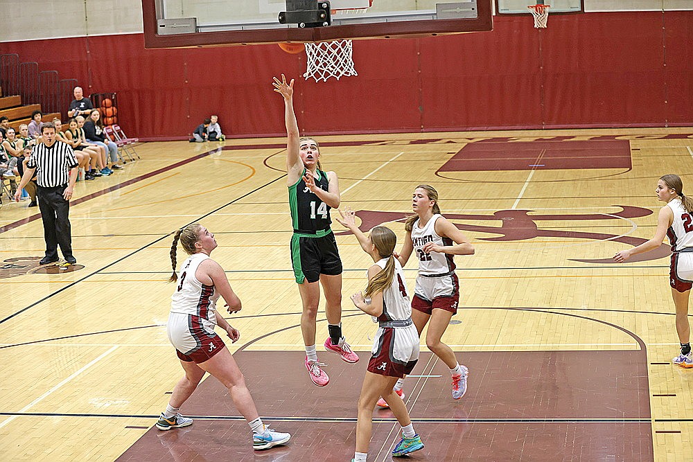 Rhinelander’s Lily Treder puts up a shot between Antigo’s Tristin Arlen (3), Kailee Krueger (4) and Jenna Czerneski (22) during the first half of a GNC girls’ basketball game at Antigo Friday, Jan. 19. Treder scored a game-high 23 points as the Hodags defeated the Red Robins, 69-43. (Bob Mainhardt for the River News)