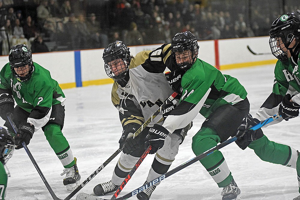 Rhinelander’s Zach Edyvean attempts to take Lakeland’s Kort Meyer off the puck during the first period of a GNC boys’ hockey game in Minocqua Thursday, Jan. 25. (Bob Mainhardt for the River News)