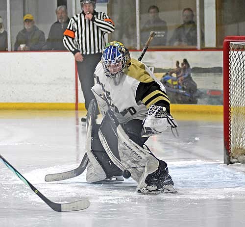 Cam Bernard puts the puck back into play in the second period of a GNC Tournament quarterfinal game against Rhinelander Tuesday, Jan. 30 at Lakeland Ice Arena in Minocqua. Bernard totaled 12 saves. (Photo by Brett LaBore/Lakeland Times)