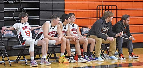 Four Tigers sit on the bench after fouling out against Drummond Friday, Feb. 2 at Coach Leverson Court in Mercer. From left, Richie Allen, Cameron-Patton Lopez, Luis Segura-Martell and Dylan Eith all fouled out in the second half as Ryan Losh and coach Mike Guild look on. (Photo by Brett LaBore/Lakeland Times)