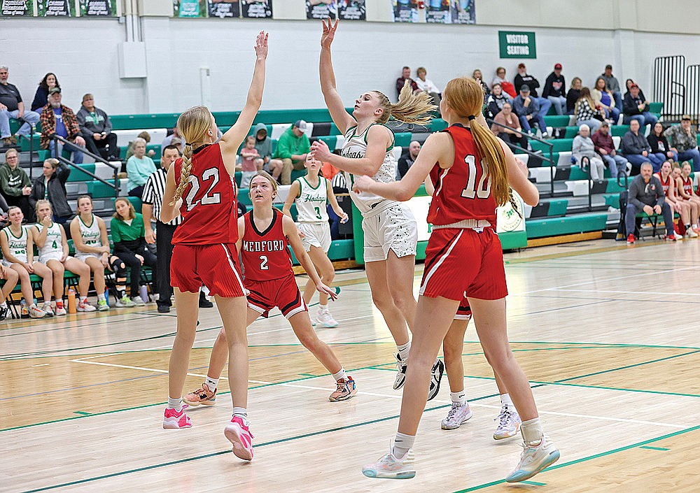 Rhinelander’s Aubryn Clark puts up a shot over Medford’s Taylor Klingbeil during the second half of a GNC girls’ basketball game at the Jim Miazga Community Gymnasium Monday, Feb. 5. Clark scored a team-high 25 points as the Hodags fended off the Raiders, 57-53. (Bob Mainhardt for the River News)