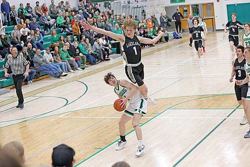 Danny Gahler goes for a block against Rhinelander’s Will Quinn Friday, Feb. 9 at Jim Miazga Community Gymnasium in Rhinelander. Gahler led Lakeland with 17 points. (Photo by Bob Mainhardt for the River News)