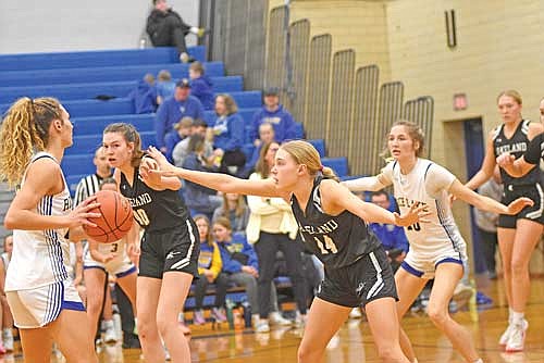 Ali Timmerman, right, and Ava Evenhouse play defense with Rice Lake’s Eli Sheplee controlling the ball in the second half Tuesday, Feb. 13 at Ole Olsen Gymnasium in Rice Lake. (Photo by Brett LaBore/Lakeland Times)