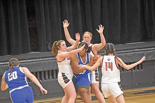 Tiger players, clockwise, Eiley Schoeneman, Ona Ruiz and Amber Eith guard Mellen’s Nylia Wiley in the first half Friday, Feb. 16 at Coach Leverson Court in Mercer. (Photo by Brett LaBore/Lakeland Times)