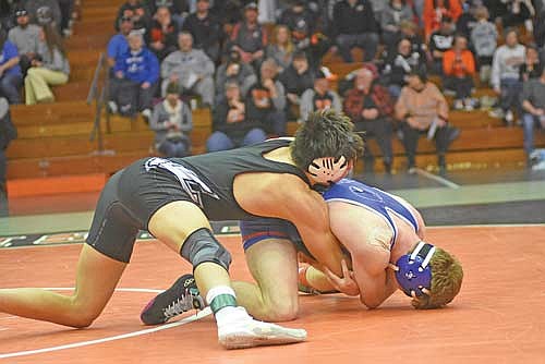 Jerome LaBarge takes down Merrill’s Callum Wheeler for two points in the third-place match at a WIAA Division 1 sectional meet Saturday, Feb. 17 at Marshfield High School. LaBarge scored two points to beat Wheeler in the final seconds. (Photo by Brett LaBore/Lakeland Times)