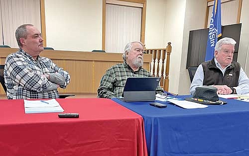 Lac du Flambeau town chairman Matt Gaulke, left, and town supervisor Bob Hanson listen to town attorney Greg Harrold speak at the beginning of the town board’s special meeting on Feb. 15. (Photo by Brian Jopek/Lakeland Times)