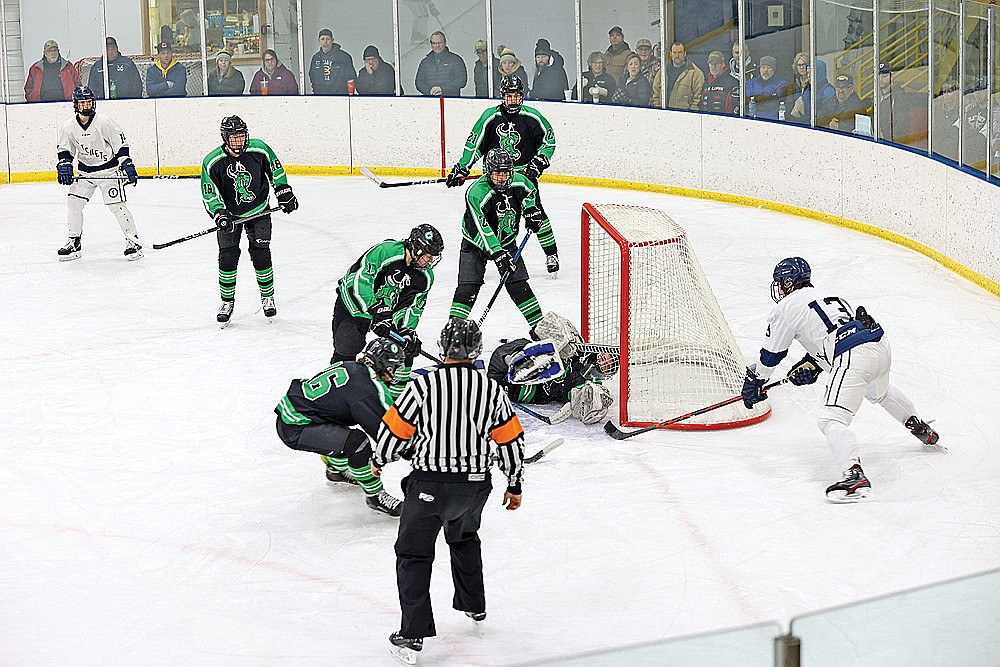 Rhinelander goalie Tyler Kimmerling sprawls to make a save against Tomahawk’s Logan Seymour during the first period of a WIAA Division 2 sectional quarterfinal game in Tomahawk Thursday, Feb. 15. Kimmerling made 36 saves at the Hodags’ season game to an end with a 5-3 loss to the Hatchets. (Bob Mainhardt for the River News)