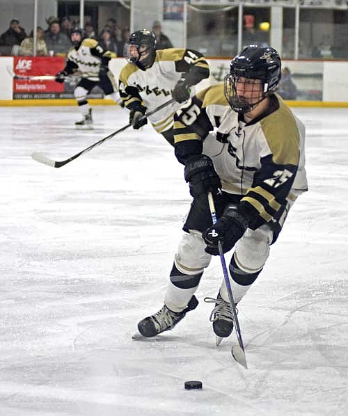 Colton Berray skates with the puck in the second period of a sectional semifinal game against Mosinee Tuesday, Feb. 20 at Lakeland Ice Arena in Minocqua. (Photo by Brett LaBore/Lakeland Times)