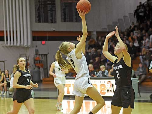 Bobbi Lee attempts a layup over Menomonie’s Mary Berg in the second half of a WIAA Division 2 sectional semifinal game Thursday, Feb. 29 at Marshfield High School. (Photo by Brett LaBore/Lakeland Times)
