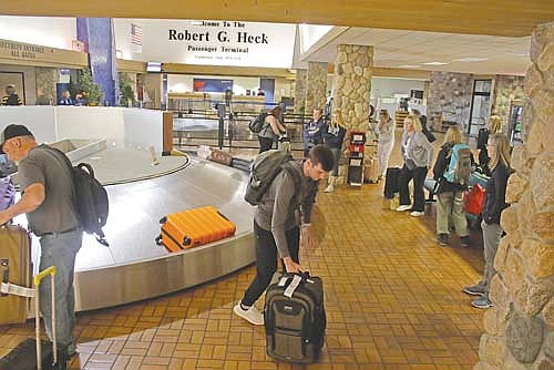 In this 2019 file photo, passengers who took a midday flight into the Rhinelander-Oneida County Airport retrieve their luggage from the baggage carousel. (River News file photo)