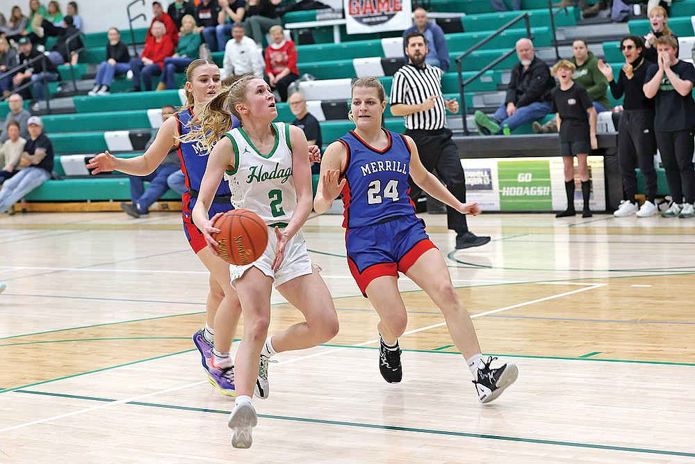 In this Dec. 22, 2023 file photo, Rhinelander’s Vivian Lamers drives past Merrill’s Brenna Jirovec for a layup during a non-conference girls’ basketball game at the Jim Miazga Community Gymnasium. Merrill will become a conference opponent for Rhinelander beginning in the fall of 2025 after the WIAA Board of Control last week approved Merrill’s request to move into the Great Northern Conference. (Bob Mainhardt for the River News)