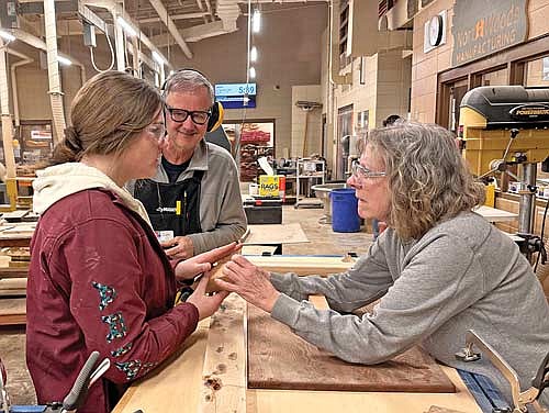 Woodworkers, from left, Taylor Shultz, Jon Olson and Kathy McCoy work together during a recent woodworking course with older Fe University students and Hurley High School teaching assistants at Hurley High School. (Contributed photograph)
