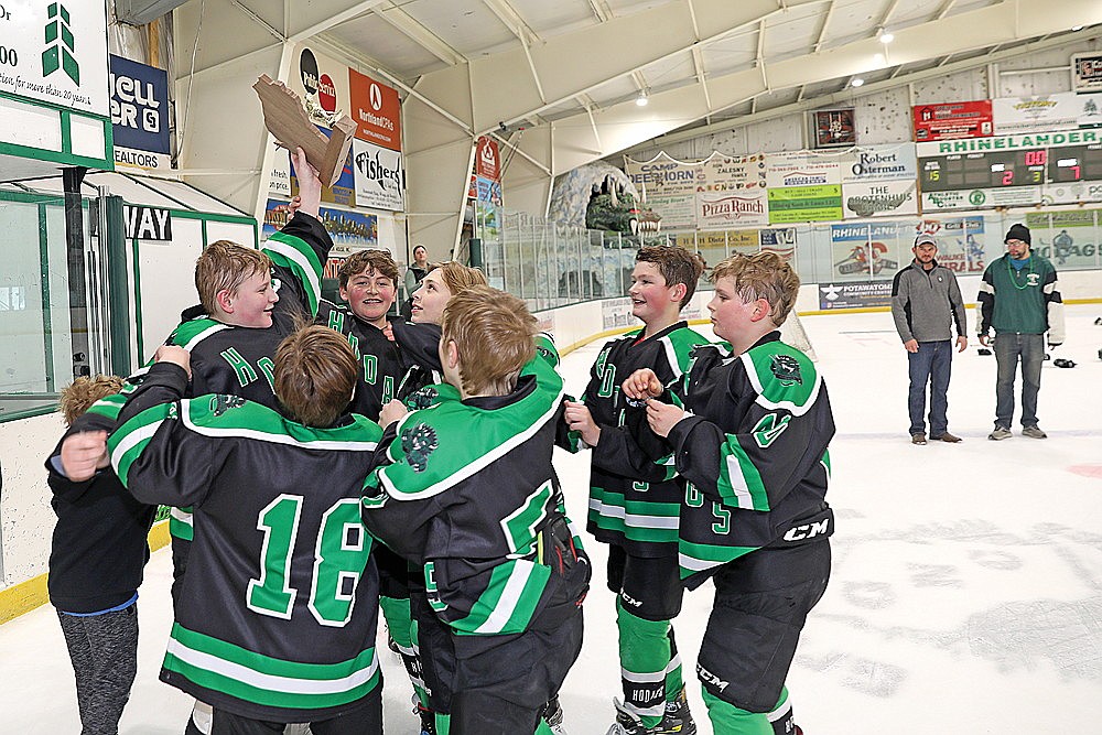 The Rhinelander Ice Association’s Peewee B team celebrates with its third-place trophy following the WAHA Peewee 3B state tournament at the Rhinelander Ice Arena Sunday, March 10. The Hodags went 2-1 on the weekend, and defeated Sauk Prairie 7-2 in the third-place game. (Bob Mainhardt for the River News)