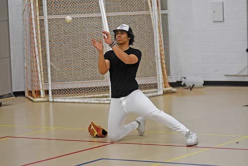 Max Keuer plays catch during the first week of practice Tuesday, March 19 at the Lakeland Union High School fieldhouse in Minocqua. (Photo by Brett LaBore/Lakeland Times)