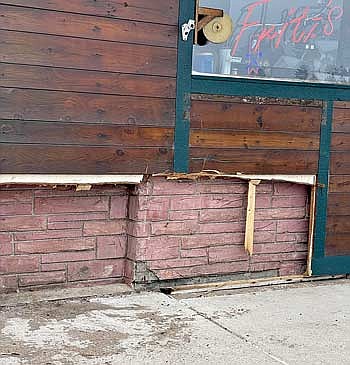 Siding material was removed early Tuesday evening by firefighters from a lower corner on the front of Fritz’s Bar and Grill in downtown Woodruff to locate the source of smoke during a fire call. (Photo by Brian Jopek/Lakeland Times)