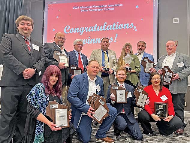 The staff of The Lakeland Times and Northwood River News show off a few of their combined 96 awards at the 2023 WNA Convention on Friday, March 15, at the Madison Concourse Hotel in downtown Madison. Top row, from left, is Jake Schexnaydre, Brian Jopek, Richard Moore, Jeremy Mayo, Heather Holmes, Gregg Walker and Dean Hall. Bottom row, Madeleine de Fore, Trevor Greene, Brett LaBore and Renee Draszkiewicz. Photo credit Greg Mellis. (Contributed photograph)