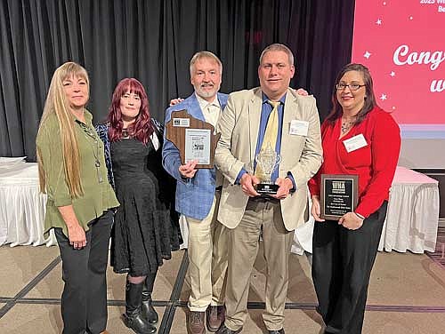 Northwoods River News general manager Heather Holmes, graphic designer Madeleine de Fore, publisher Gregg Walker, sports editor Jeremy Mayo and marketing manager Renee Draszkiewicz celebrate the River News Best in Division award Friday, March 15, 2024 at the Wisconsin Newspaper Association convention in Madison. Editor Heather Schaefer was unavailable for the photograph. (Photo courtesy of Greg Mellis)