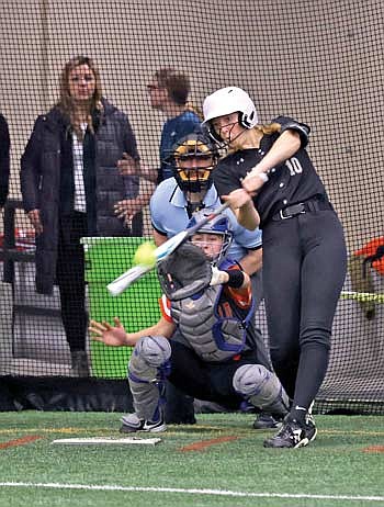 Saylor Timmerman blasts a three-run home run in the fifth inning against Marshfield in a season-opening tournament Thursday, March 21 at the Hodag Dome in Rhinelander. Timmerman picked up two wins over the weekend with two earned runs given up in 21 innings. (Photo by Bob Mainhardt for the River News)