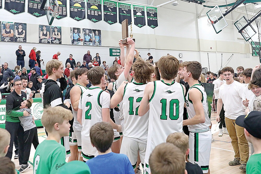 In this Feb. 22, 2024 file photo, Rhinelander’s Will Gretzinger lifts the Great Northern Conference championship trophy surrounded by his teammates after the Hodags defeated the Medford Raiders 50-45 at the Jim Miazga Community Gymnasium. The Hodags shared the GNC title with Mosinee this year, earning their first conference title since 2018. (Bob Mainhardt for the River News)