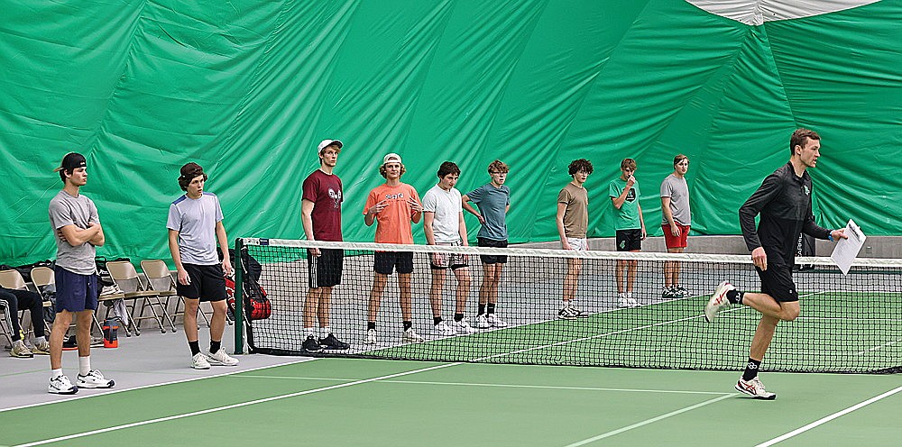 Coach Matt Nichols, right, demonstrates a warmup exercise during Rhinelander High School boys’ tennis practice in the Hodag Dome Monday, March 25. (Bob Mainhardt for the River News)