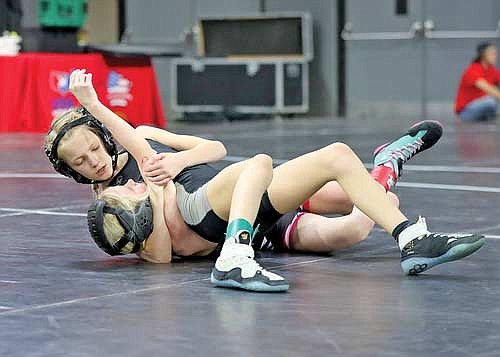 Kennedy Howard, top, wrestles against Brillion’s Vayda Van Camp in the first-place match at the Wisconsin Wrestling Federation Kids Folkstyle State Championship Friday, March 22 to Sunday, March 24 at Alliant Energy Center in Madison. Howard pinned Van Camp in 1:37. (Contributed photograph)