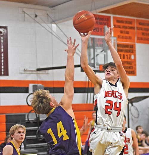 In this Feb. 2, 2024 file photo, Conrad LaBarge takes a shot over Drummond’s Blake Williamson in the second half at Coach Leverson Court in Mercer. (Photo by Brett LaBore/Lakeland Times)