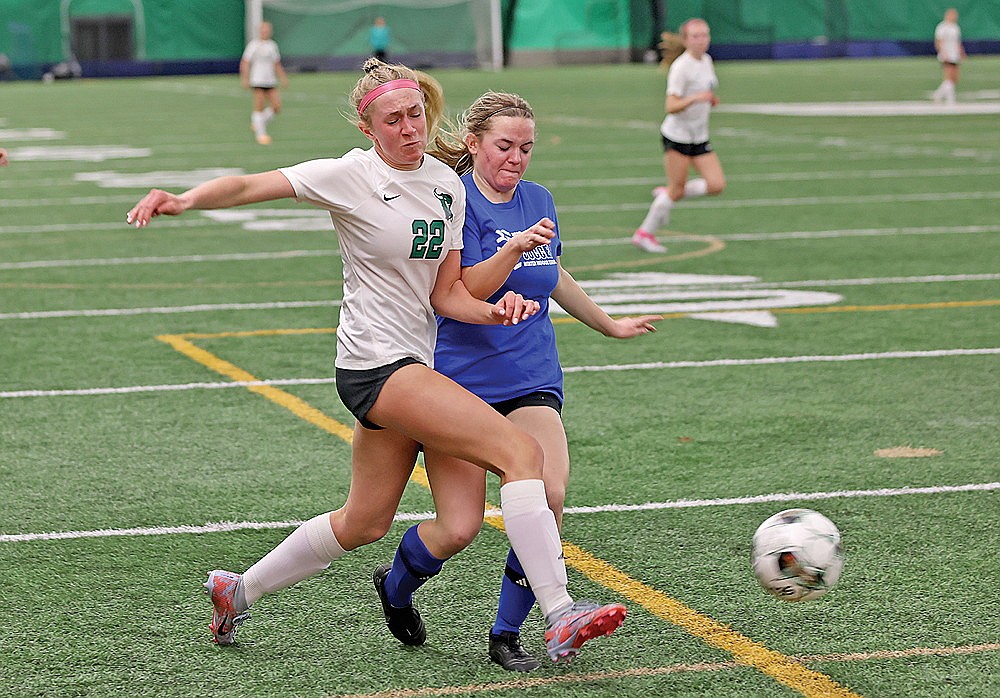 Rhinelander’s Vivian Lamers challenges a Merrill defender for the ball during a girls’ soccer scrimmage in the Hodag Dome Thursday, March 28. (Bob Mainhardt for the River News)