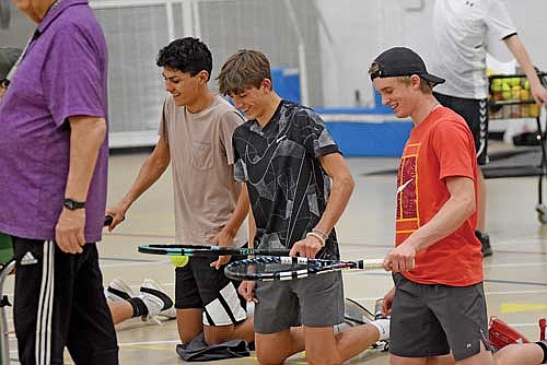 Players, from left, Dominic Gironella, Angus Callender and Jack Stepec practice their serving during the first day of practice Wednesday, March 27 at the Lakeland Union High School fieldhouse in Minocqua. (Photo by Brett LaBore/Lakeland Times)