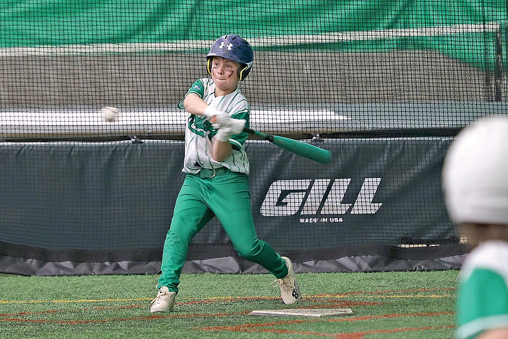 Cameron Olson swings away at a pitch during the 11U championship game against Hallie.
