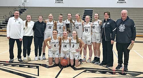 In this Feb. 24, 2024 file photo, the Lakeland girls’ basketball team celebrates their regional championship after beating Rice Lake 70-69 at Ted Voigt Court in Minocqua. Players pictured, front from left, are Alee Holmes, Ali Timmerman and Bobbi Lee; back row, coach Brad Meade, Sarah Barton, Sophie Wiczek, Alyssa Meade, Alyssa Erickson, Kristina Ouimette, Saylor Timmerman, Cale Quade, Ava Evenhouse, head coach Melissa Ouimette and coach Larry Ouimette. (Photo by Brett LaBore/Lakeland Times)