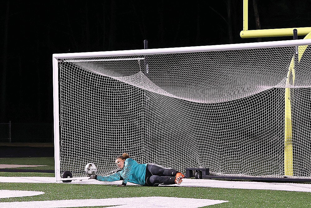 Rhinelander’s Mya Krouze attempts to save a penalty kick by Medford’s Talyn Peterson during a GNC girls’ soccer game at Mike Webster Stadium Thursday, April 18. Though Krouze deflected the shot, the ball glanced off the left post and in to tie the shootout. Medford eventually won the shootout, 4-3, after the teams played to a scoreless tie in regulation. (Bob Mainhardt for the River News)