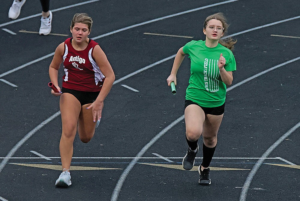 Marisa Hartman races an Antigo runner in the girls’ 4x200-meter relay during a middle school track meet Monday, April 22 at Mike Webster Stadium.