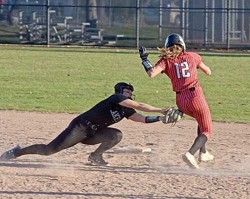 Marlee Strasburg tags out Medford’s Chelsea Gebauer on a stolen base attempt in the 11th inning Thursday, April 25 at Lenz Field in Minocqua. (Photo by Brett LaBore/Lakeland Times)